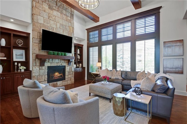 16305 Flint St, Overland Park, KS 66221 - living room featuring a stone fireplace, beamed ceiling, wood finished floors, a towering ceiling, and baseboards