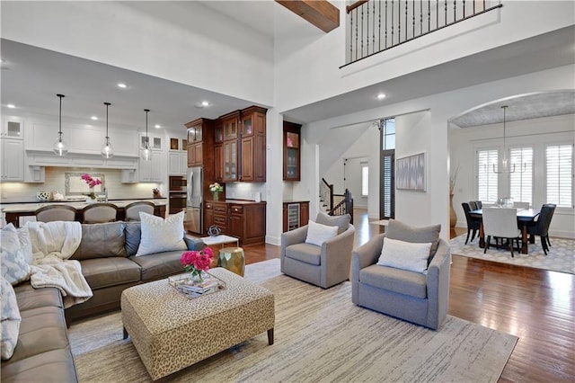 16305 Flint St, Overland Park, KS 66221 - living area with light wood-style flooring, recessed lighting, stairs, arched walkways, and baseboards
