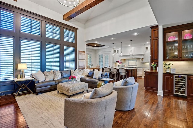 16305 Flint St, Overland Park, KS 66221 - living area with beverage cooler, dark wood finished floors, plenty of natural light, a towering ceiling, and beam ceiling