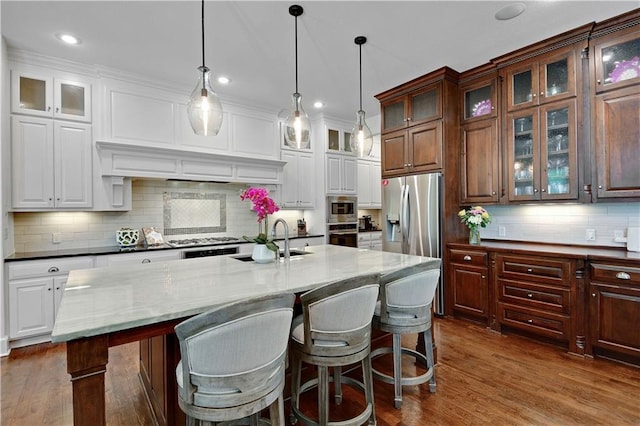 16305 Flint St, Overland Park, KS 66221 - kitchen with stainless steel appliances, a sink, decorative backsplash, white cabinets, and recessed lighting
