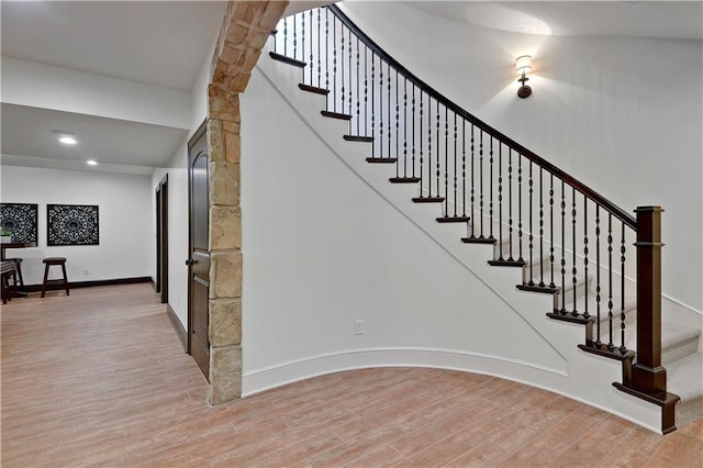 16305 Flint St, Overland Park, KS 66221 - stairs featuring wood finished floors, baseboards, and recessed lighting