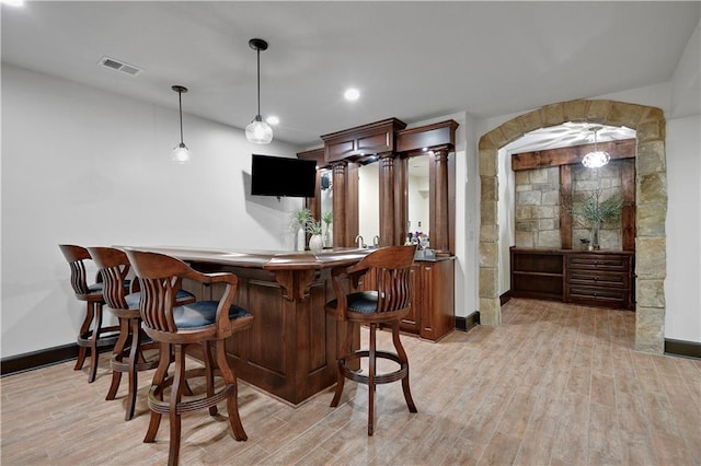 16305 Flint St, Overland Park, KS 66221 - indoor wet bar with light wood-style flooring, baseboards, decorative light fixtures, and recessed lighting