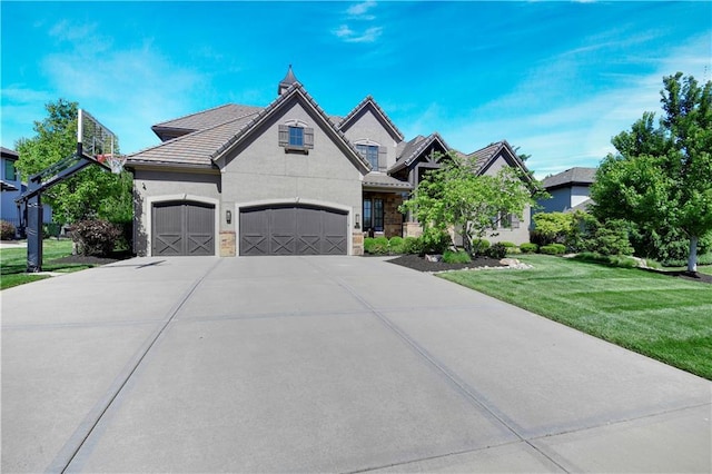 16305 Flint St, Overland Park, KS 66221 - french country home with a front lawn, driveway, a tiled roof, a garage, and stucco siding