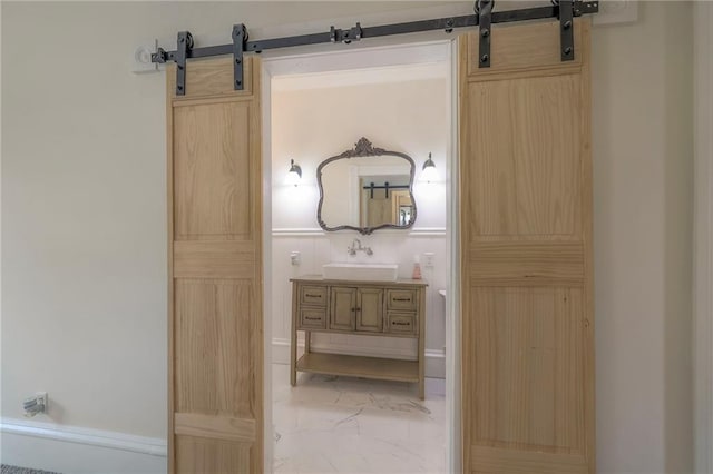 bathroom featuring marble finish floor and vanity