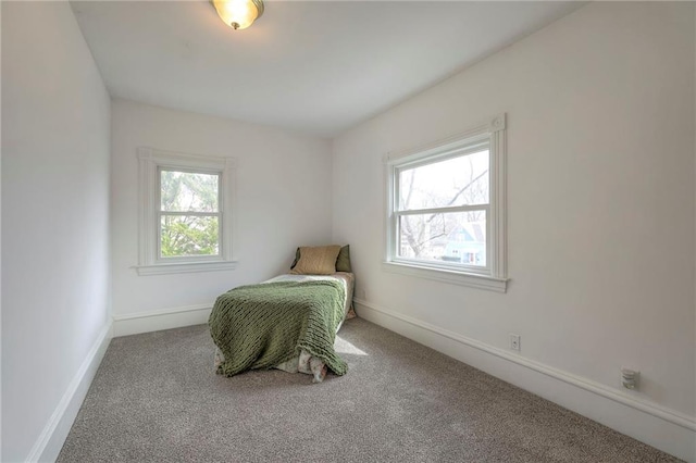 carpeted bedroom featuring baseboards