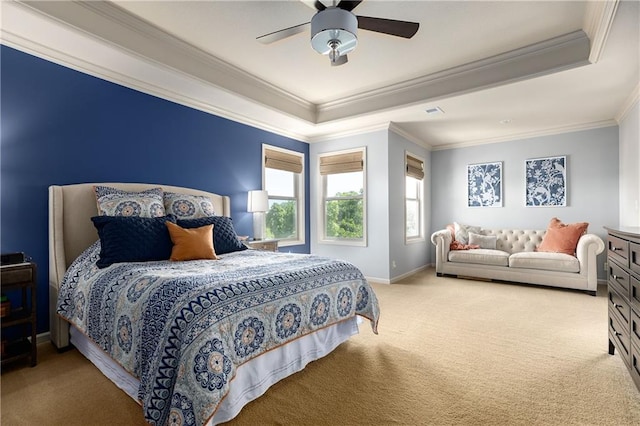 bedroom featuring a tray ceiling, carpet flooring, ornamental molding, ceiling fan, and baseboards