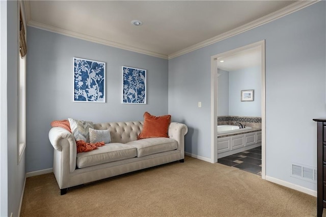 carpeted living area with ornamental molding and baseboards