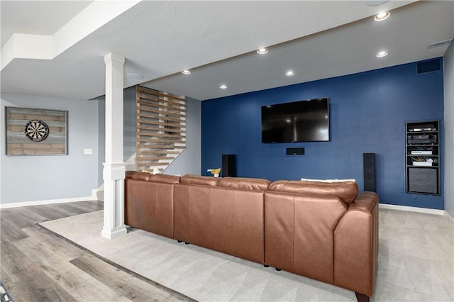 living room featuring light wood-type flooring, baseboards, decorative columns, and recessed lighting