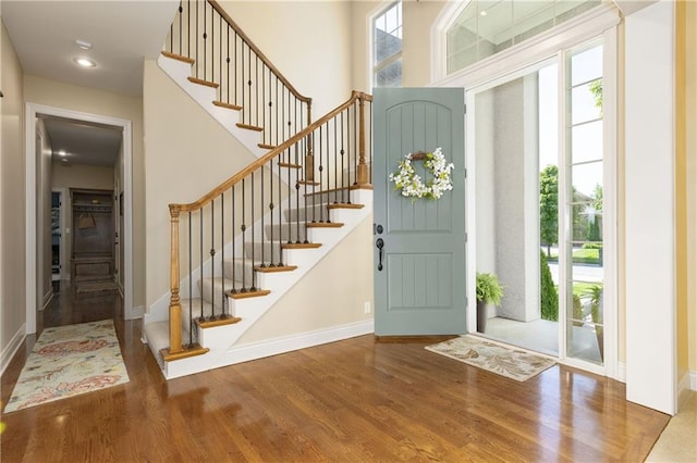 10804 W 169th St, Overland Park, KS 66221 - entrance foyer with wood finished floors, plenty of natural light, baseboards, stairway, and a towering ceiling