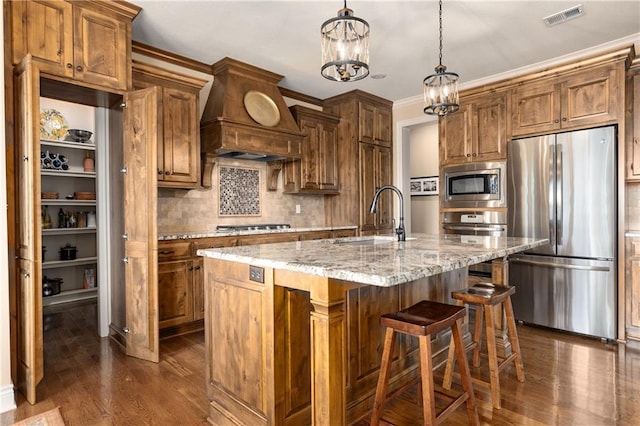 10804 W 169th St, Overland Park, KS 66221 - kitchen with appliances with stainless steel finishes, a sink, range hood, decorative backsplash, and dark wood-style floors