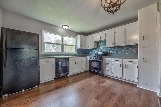 kitchen with white cabinetry, decorative backsplash, black appliances, an inviting chandelier, and dark wood finished floors