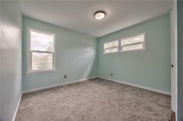 empty room with baseboards and carpet floors