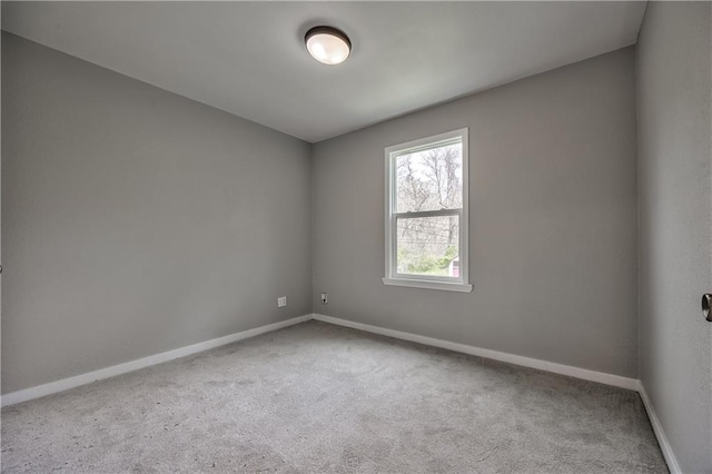 unfurnished room featuring baseboards and carpet floors