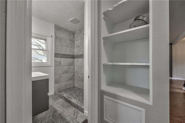 full bathroom with tiled shower
