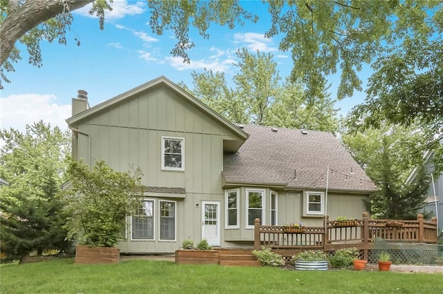 15819 W 147th Ter, Olathe, KS 66062 - rear view of property with a shingled roof, a chimney, a lawn, a wooden deck, and board and batten siding