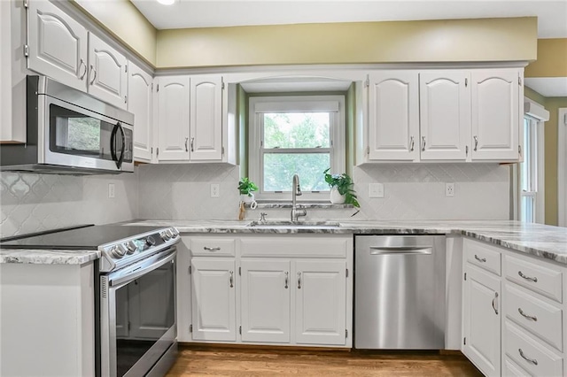 15819 W 147th Ter, Olathe, KS 66062 - kitchen with stainless steel appliances, a sink, and white cabinetry