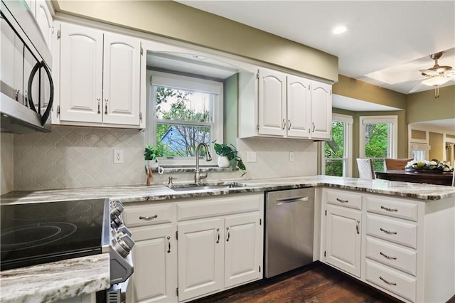 15819 W 147th Ter, Olathe, KS 66062 - kitchen with appliances with stainless steel finishes, a sink, healthy amount of natural light, light stone counters, and recessed lighting