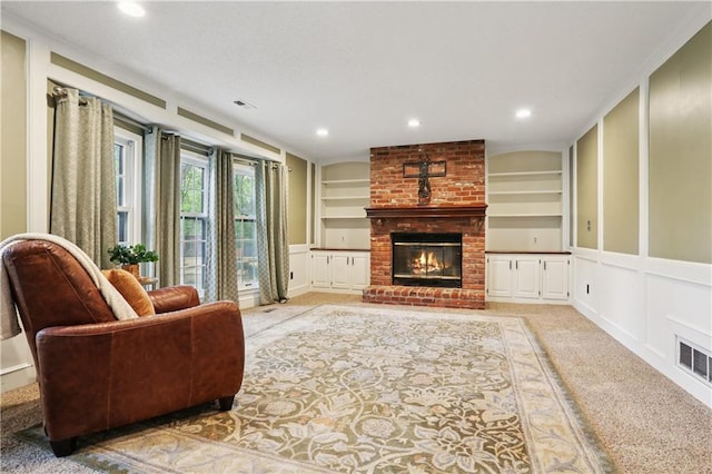 15819 W 147th Ter, Olathe, KS 66062 - living area featuring built in shelves, a decorative wall, light carpet, a fireplace, and recessed lighting