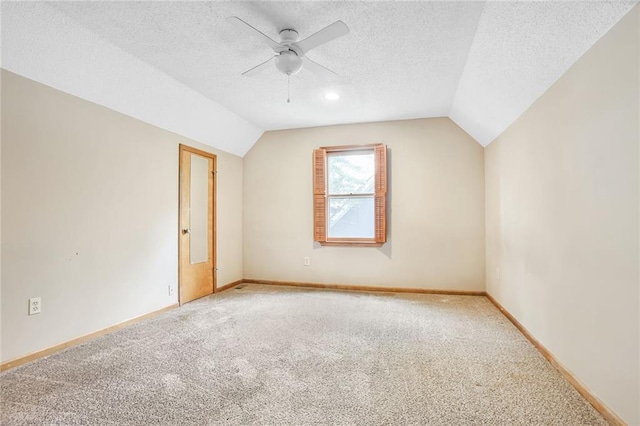 15819 W 147th Ter, Olathe, KS 66062 - additional living space with light colored carpet, ceiling fan, vaulted ceiling, baseboards, and a textured ceiling