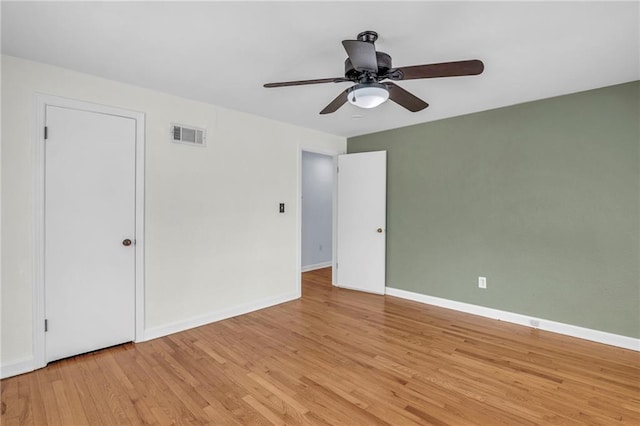 unfurnished bedroom featuring baseboards, visible vents, ceiling fan, and light wood-type flooring