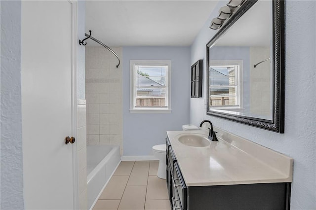 full bath featuring tile patterned flooring, vanity, toilet, baseboards, and bathtub / shower combination