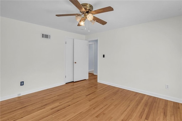 spare room with a ceiling fan, baseboards, visible vents, and light wood-style flooring