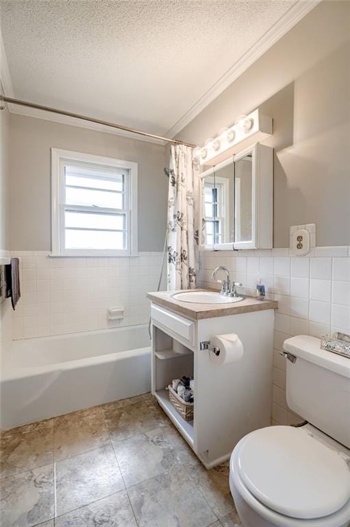 bathroom featuring a textured ceiling, crown molding, tile walls, toilet, and shower / bath combo with shower curtain