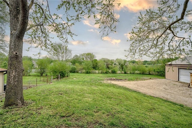 view of yard with an outbuilding and driveway