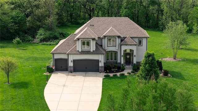 13017 Kelli Dr, Kearney, MO 64060 - french country home with stucco siding, concrete driveway, a front lawn, an attached garage, and roof with shingles