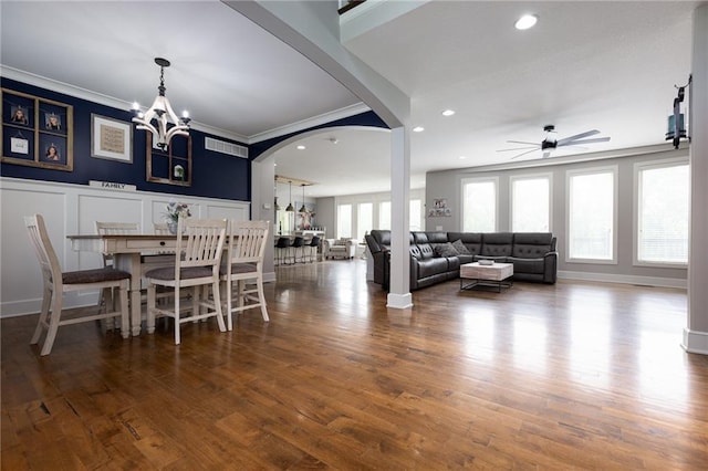 13017 Kelli Dr, Kearney, MO 64060 - dining area with ceiling fan, arched walkways, crown molding, a decorative wall, and wood finished floors