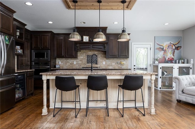 13017 Kelli Dr, Kearney, MO 64060 - kitchen with black appliances, backsplash, dark brown cabinetry, and recessed lighting