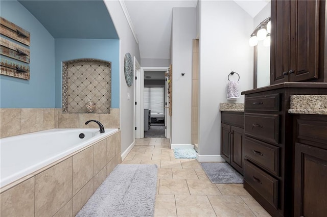13017 Kelli Dr, Kearney, MO 64060 - bathroom featuring vanity, a garden tub, baseboards, and tile patterned flooring