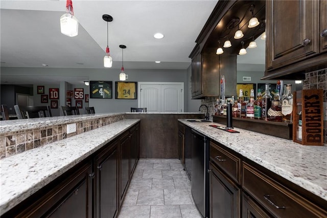 13017 Kelli Dr, Kearney, MO 64060 - bar area featuring a sink, stone finish floors, hanging light fixtures, backsplash, and recessed lighting