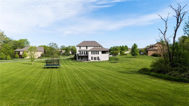 13017 Kelli Dr, Kearney, MO 64060 - rear view of property featuring a trampoline and a yard