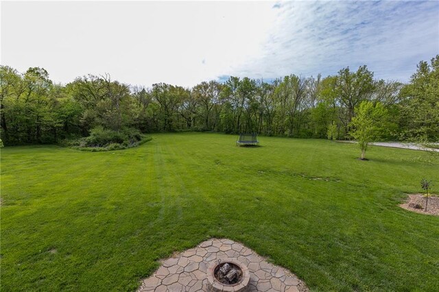 13017 Kelli Dr, Kearney, MO 64060 - view of grassy yard featuring an outdoor fire pit and a patio area
