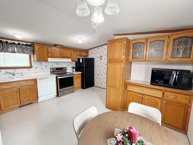 kitchen featuring wallpapered walls, under cabinet range hood, black appliances, a sink, and a textured ceiling