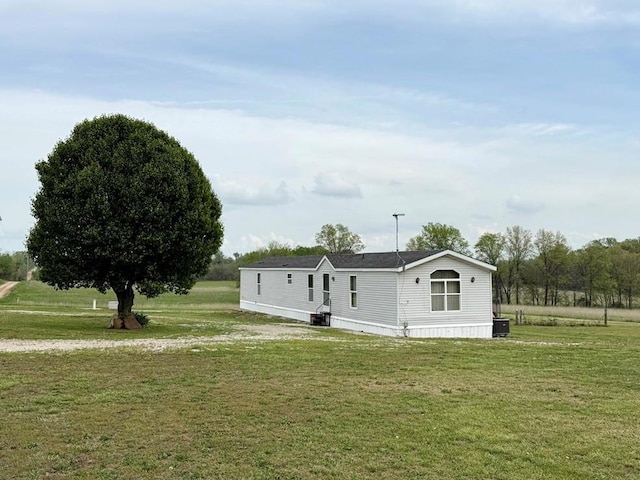 view of front facade with a front lawn and central AC unit