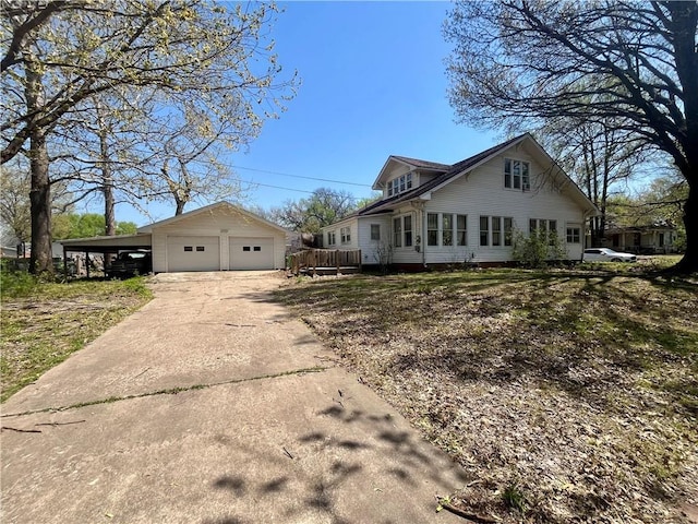 view of side of property featuring an outbuilding and a garage