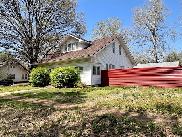 view of property exterior featuring a shingled roof