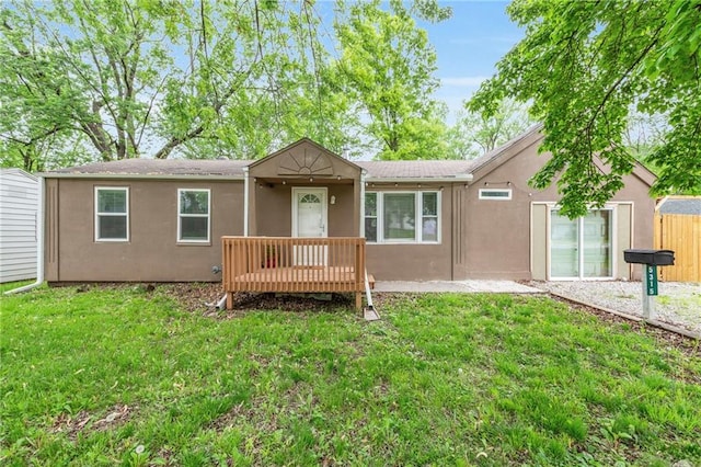 5315 Hardy Ave, Raytown, MO 64133 - back of property featuring a lawn, stucco siding, and fence