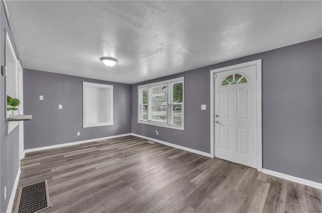 5315 Hardy Ave, Raytown, MO 64133 - entrance foyer featuring baseboards, wood finished floors, and visible vents