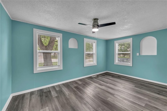 5315 Hardy Ave, Raytown, MO 64133 - empty room with a ceiling fan, baseboards, a healthy amount of sunlight, and wood finished floors
