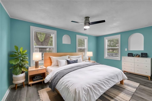 5315 Hardy Ave, Raytown, MO 64133 - bedroom featuring baseboards, wood finished floors, and multiple windows