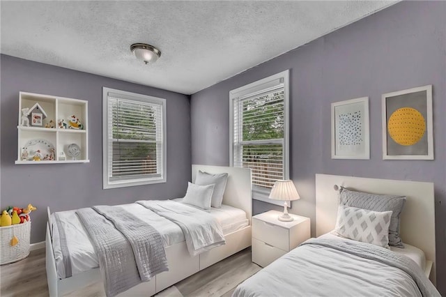 5315 Hardy Ave, Raytown, MO 64133 - bedroom featuring a textured ceiling and wood finished floors