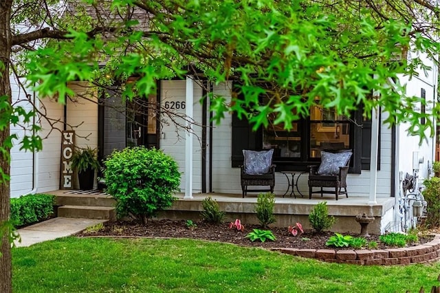 exterior space featuring covered porch and a yard