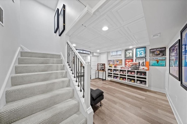 staircase featuring an ornate ceiling, recessed lighting, baseboards, wood finished floors, and visible vents