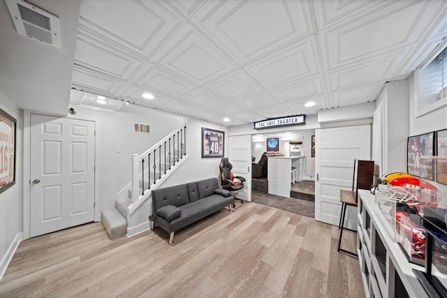 living room featuring visible vents, recessed lighting, light wood-style flooring, and stairs