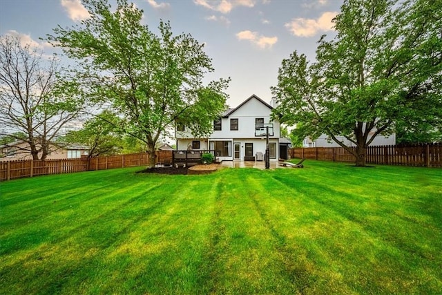 back of house with a lawn, a fenced backyard, and a patio area