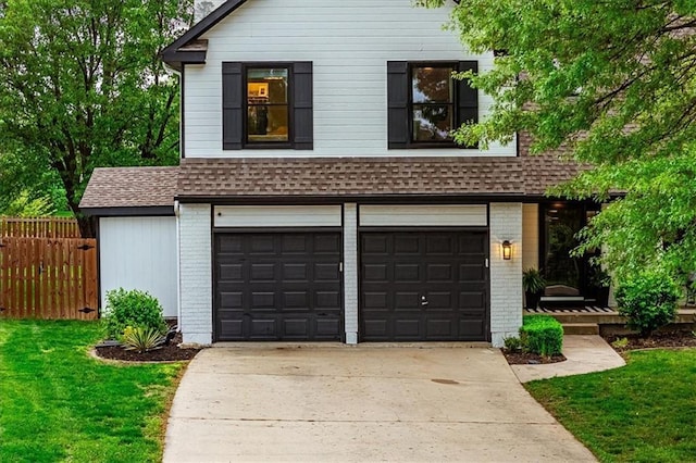 garage featuring concrete driveway and fence