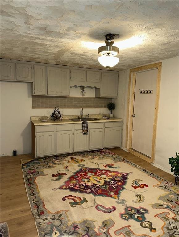 300 W Sea Ave, Independence, MO 64050 - kitchen featuring light countertops, light wood-style flooring, and a sink